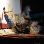 A puppeteer performs a traditional Wayang puppet show in Central Java, Indonesia.