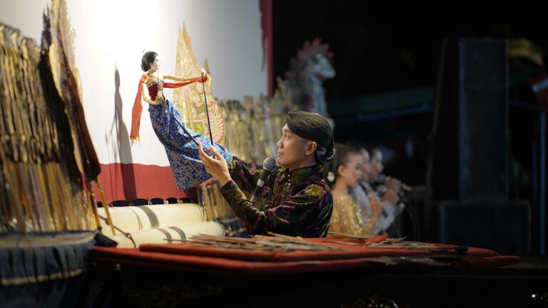 A puppeteer performs a traditional Wayang puppet show in Central Java, Indonesia.